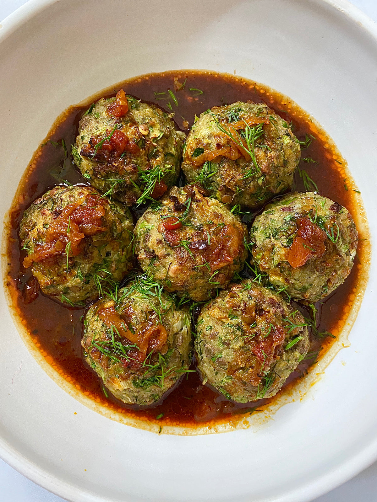 The Grand Koofteh — five herbed meatballs in a white bowl, from Souki’s kitchen
